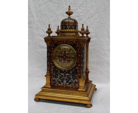 A 19th century gilt metal and champleve enamel decorated mantle clock, with a vase finial and dome , the four corners mounted