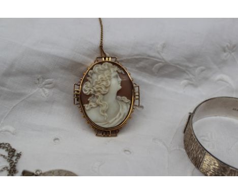 A shell cameo brooch depicting a lady in profile in a yellow metal mount together with a silver locket and a silver hinged ba