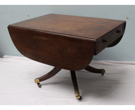 A Regency mahogany sofa table the rectangular top with drop flaps above drawers to either end on  a turned column and four sp