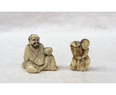 An ivory netsuke in the form of a seated bearded gentleman holding a bowl, 4.5cm high together with another netsuke of child 