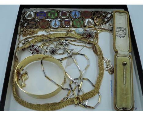 A selection of gold plated costume jewellery including plaited collarette, hinged bangle, dress rings, Paris souvenir bracele