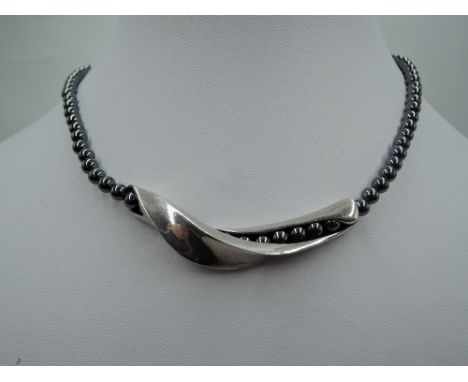 A hematite bead necklace by Georg Jensen having a central silver slide twist panel, approx 35g