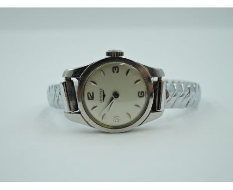 A lady's Longines manual wrist watch having Arabic and baton numeral dial to silvered face in steel case on a later stretch s