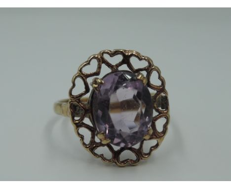 An amethyst dress ring within a heart patterned mount on a 9ct gold loop, size M &amp; approx 2.7g