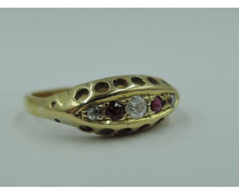 A ruby and diamond chip dress ring having boat gallery mount on a yellow metal loop stamped 18ct, size K &amp; approx 2.2g