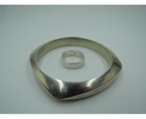 A silver bangle of angled heavy form and a matched ring also stamped 925, approx 76.1g