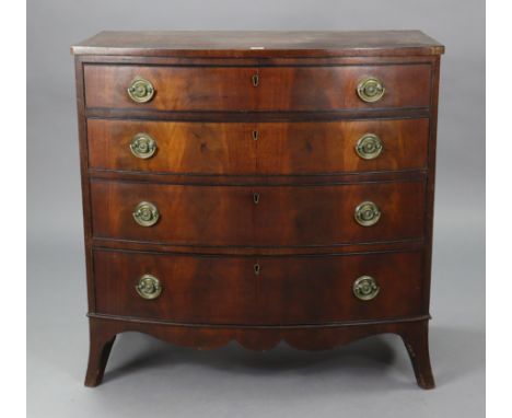 A Georgian mahogany bow-front chest fitted four long graduated drawers with brass swing handles, &amp; on ogee bracket feet (