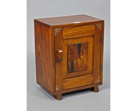 A Japanese hardwood small cupboard fitted with a centre shelf enclosed by a panel door, 11¾” wide x 15” high.