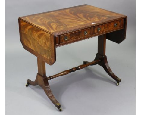 A reproduction mahogany sofa table fitted two frieze drawers, &amp; on square end supports &amp; splay legs joined by a turne