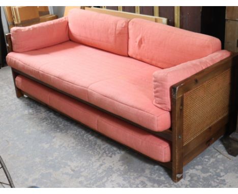 A pine-frame sofa bed inset with woven-cane panels to sides, on square supports, complete with cushions, 79” long.