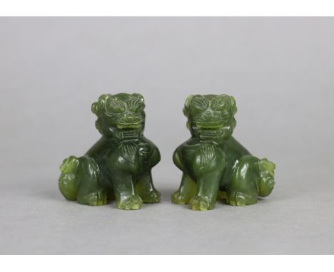 A pair of Chinese small carved jade temple-dog ornaments, 2¼” high.