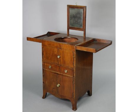 A George III mahogany washstand with envelope top enclosing a rise-&amp;-fall swing mirror, two pairs of panel doors &amp; fr