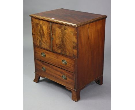 A Georgian mahogany small cabinet enclosed by a pair of panel doors above two long drawers, &amp; on bracket feet, 25½” wide 