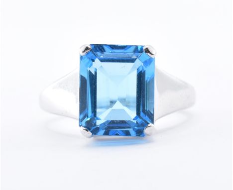 A hallmarked 9ct white gold ring set with a rectangular cut blue topaz. Hallmarked Birmingham 2006. Weight 5.6g. Size N.5. St