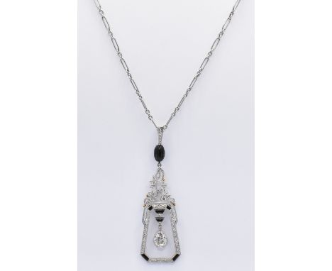 A 1930's Art Deco pendant necklace having a geometric open work pendant set with a large tear drop cut diamond with diamond a