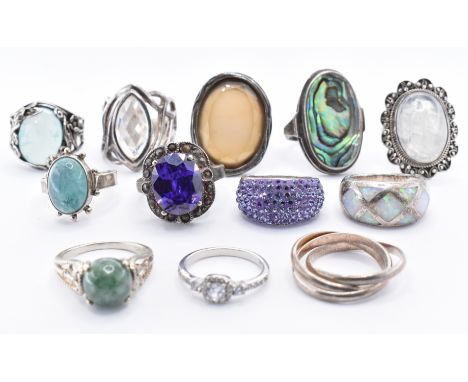 A group of twelve silver dress rings to include an abalone shell panel ring, a purple stone dress ring, a moonstone cabochon 