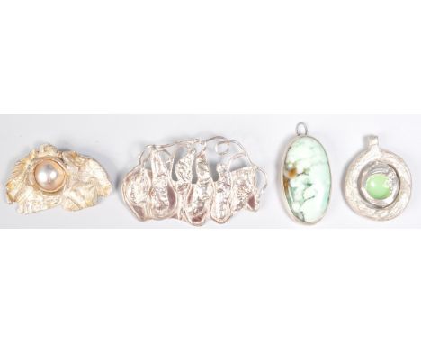 A group of silver studio art jewellery to include two pendant slides of moulded form one being set with a half pearl, one pen