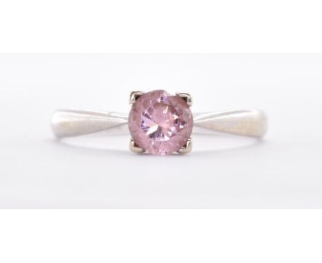 A hallmarked 9ct white gold solitaire ring being set with a round cut pink stone. Assay marked London. Weight 2.2g. Size P.