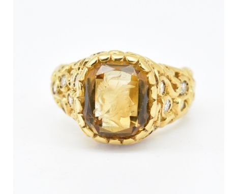 A French 18ct gold citrine and diamond ring having a cushion cut citrine to the head an an engraved intaglio soldiers head wi