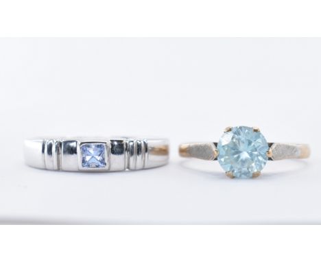 Two 9ct gold rings to include a blue stone solitaire ring having textured white metal shoulders (assay marked London, size k)