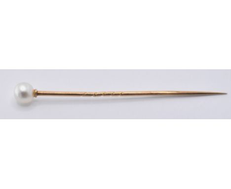 A gold and natural pearl stick pin having a round white pearl set to the finial with a twist design pin below, set within a C