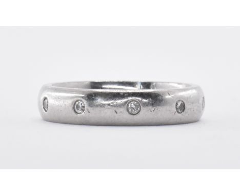 A ladies platinum band ring being set with ten round cut diamonds. Hallmarked Birmingham 2007. Weight 7.2g. Size J.5.