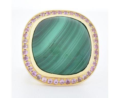 A Danish 18ct gold malachite and pink sapphire cocktail ring. The ring set with a cushion cut malachite cabochon framed by ro