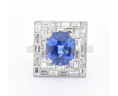 A French 18ct gold sapphire and diamond cocktail ring having a rectangular head set with baguette cut diamonds set with a cus