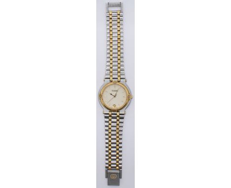 A Gucci stainless steel wrist watch having a round white face with baton numerals to the chapter ring and date aperture to si
