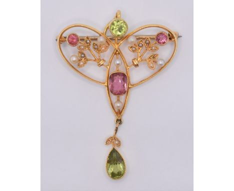 An early 20th Century Art Nouveau brooch pin of open work knot design, being set with three pink tourmaline stones, with a ro