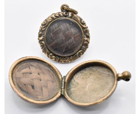 Two 19th century Victorian mourning lockets to include one having a hair work panel to the front within a scrolled and engine