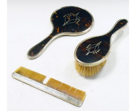 George V silver and tortoiseshell three piece brush set comprising: hand mirror, brush and comb, Birmingham 1922   Condition: