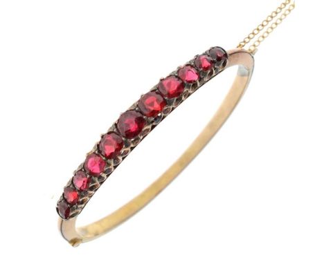 Gold coloured metal snap bangle set graduated red stones, 10g approx   Condition: 