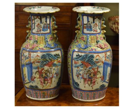 Pair of 19th Century Chinese porcelain baluster shaped vases, each having four reserves depicting figures on a terrace and in