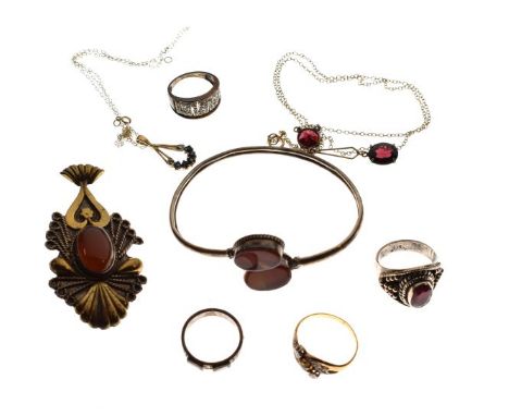 Four dress rings, boxed, an open bangle, and two neck chains with pendants   Condition: 