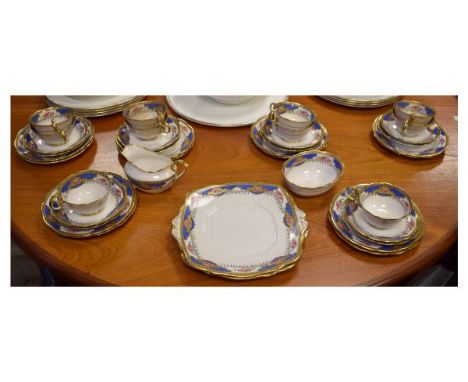 Quantity of Royal Albert Crown china tea ware having pink rose transfer printed decoration against a blue scale ground border