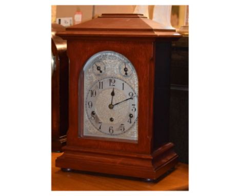 Early 20th Century German three-train chiming bracket clock, the arched silvered dial with Arabic chapter ring beneath two su