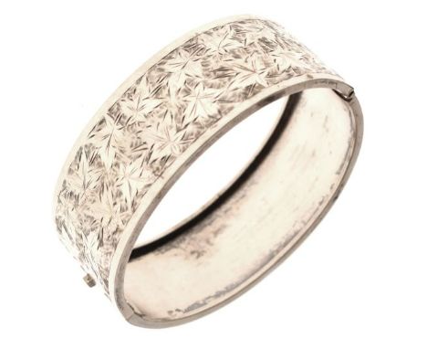 White metal snap bangle having engraved foliate decoration   Condition: 