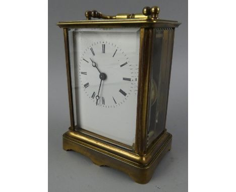 A French brass striking carriage clock, the white enamel dial with black Roman numerals, the movement signed Aigulles, striki