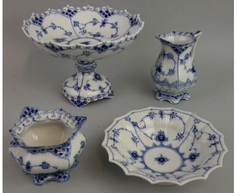 A Royal Copenhagen porcelain tazza, in the Lace and Devil pattern, 1020, a bowl, 141, a sugar bowl, 1112 and a milk jug, 1140