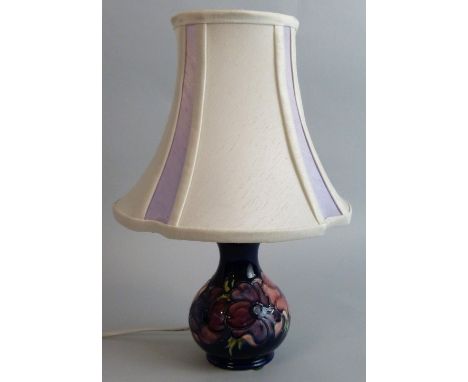 A Moorcroft 'Clematis' pattern tubeline decorated baluster lamp base, on dark blue ground, impressed marks, height 16 cm.