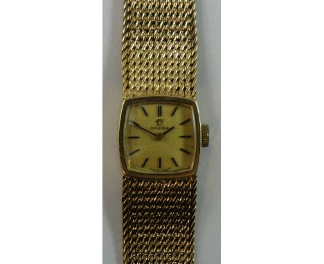 Omega - a ladies 9ct gold manual wind wristwatch, with gilt dial, woven bracelet, weight without movement 27 g.
