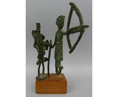 Two archaic type statues, one with a bow and arrow, the other with a walking stick, height 21 cm.