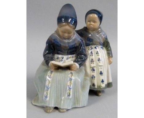 A Royal Copenhagen porcelain group of a mother reading to her daughter, numbered 1395.