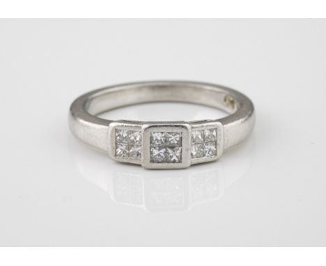 A platinum and diamond ring, set with twelve princess cut diamonds, total weight approx. 0.50ct, size K.