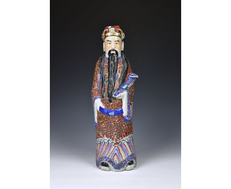 A Chinese porcelain famille rose figure of an Immortal, probably late 19th / early 20th century, polychrome enamelled and enr