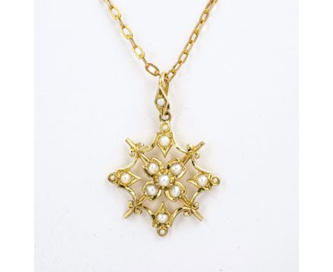 A Victorian 9ct gold and seed pearl snowflake pendant, on a Victorian 9ct gold trace chain.