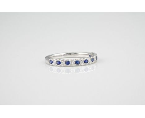 An 18ct white gold, sapphire and diamond half eternity ring, with alternate round cut sapphires and brilliant cut diamonds, w