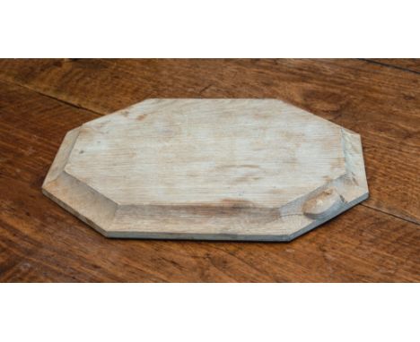 A Robert Mouseman Thompson of Kilburn carved oak cheese or bread board, octagonal form with chamfered edge and carved mouse t