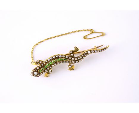 An antique 18ct gold, ruby, peridot and seed pearl lizard brooch, early 20th century, the realistically modelled lizard set w